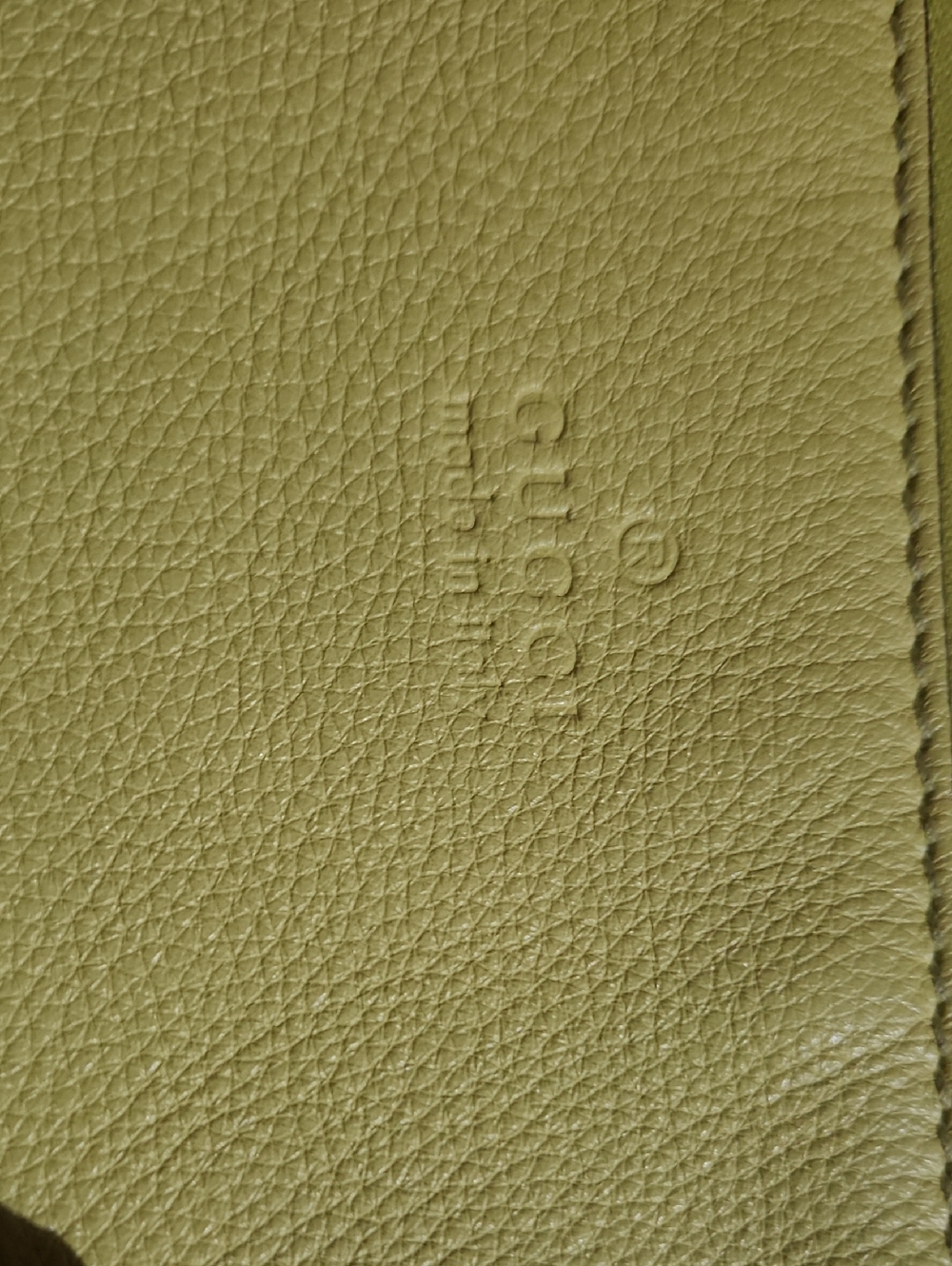 Yellow Gucci pebbled leather large clutch featuring a signature bamboo tassel